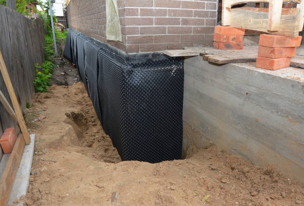 Happy homeowners after waterproofing job in Sheridan